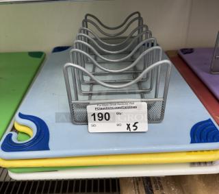 Set of 5 cutting boards with rack, various colors, gently used. Auction tag shows item number 190, bid times 5.