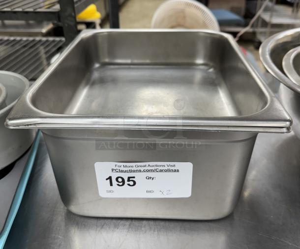 Stainless steel 1/3 x 6 pan with lids, shown with auction tag "195," in used condition.
