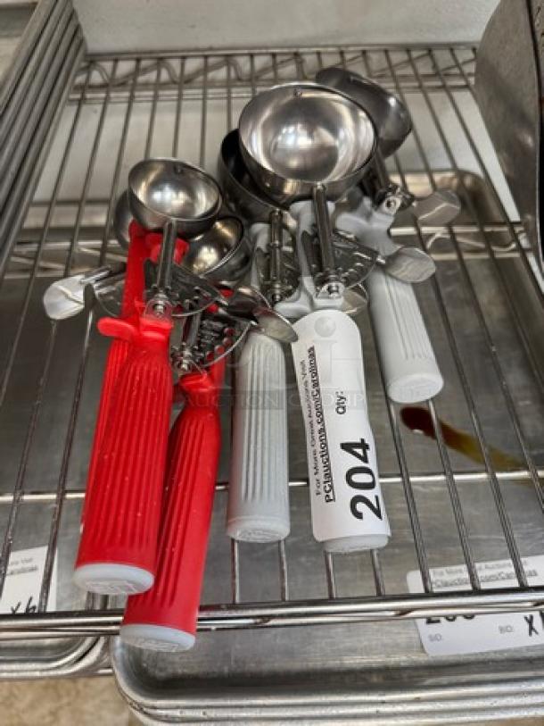 Vollrath metal ice cream scoops, set of 6; red and white ribbed handles; numbered tags visible; used condition.