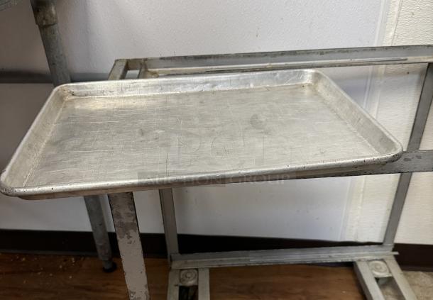 Half size sheet pan in used condition, shows surface scratches and minor dents. Auction for set of 6 pans.