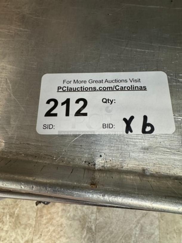 Half-size sheet pans; set of 6. Visible label: Auction ID 212, refers to a larger auction event. Signs of wear present.