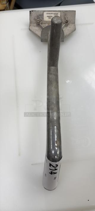 Metal grill scraper with a long handle, showing signs of wear. Labeled "214." Appears durable and functional.