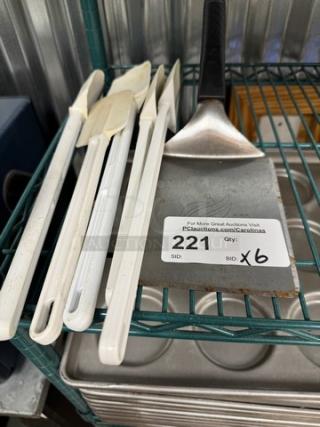 Set of kitchen mixing spoons and spatulas, six pieces, white handles, labeled "221" with auction info. Good condition.