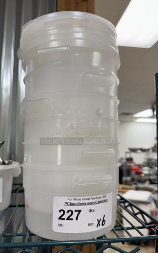 Stack of 2 Qt. round containers with 4 lids, auction tag shows lot number 227, bid quantity x6.