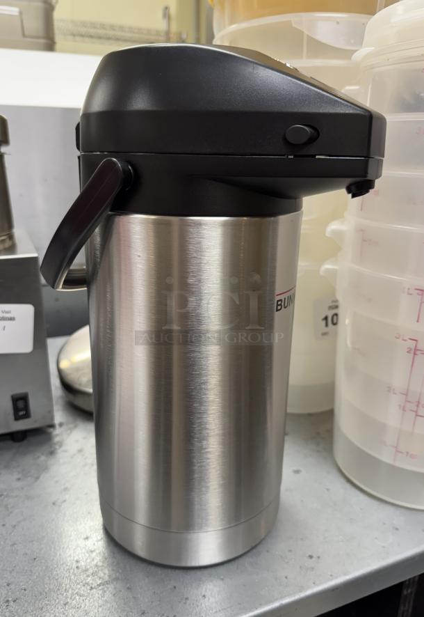 NEW Bunn Air Pot, stainless steel, black lid, brand logo visible, perfect condition, ideal for hot beverage storage.