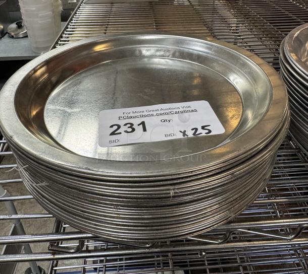 Stack of metal pie pans, 25 total, on wire shelf. Label indicates auction item number 231, bid quantity x25.