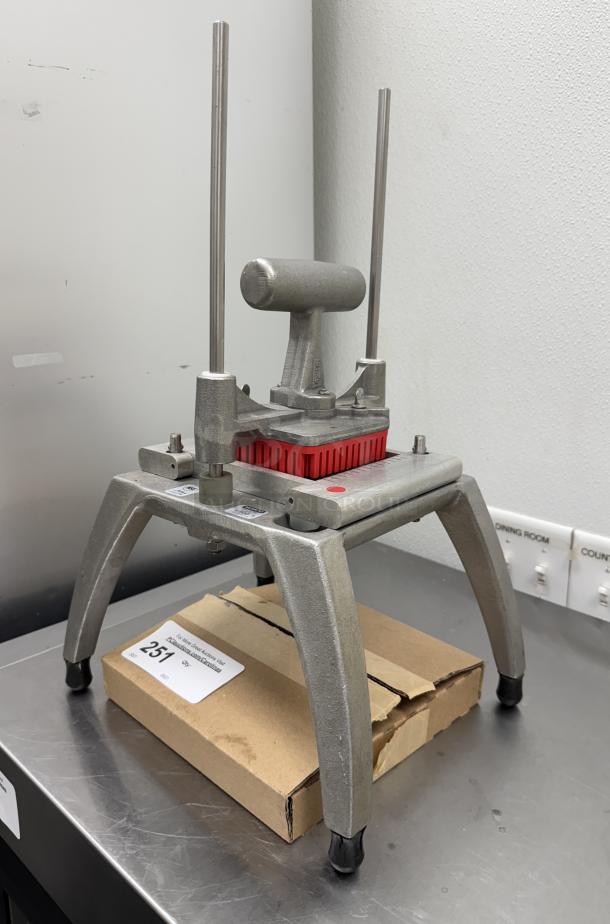 KEMCO Manual Dicer/Slicer with extra blades, robust metal frame, used condition, on a stainless steel surface, includes box.