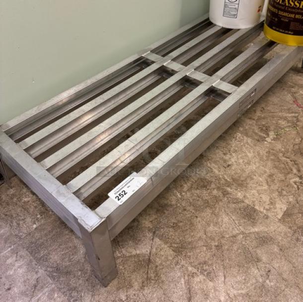 Metal dunnage rack with slatted top, sturdy construction, good condition. Label indicates auction lot 252.