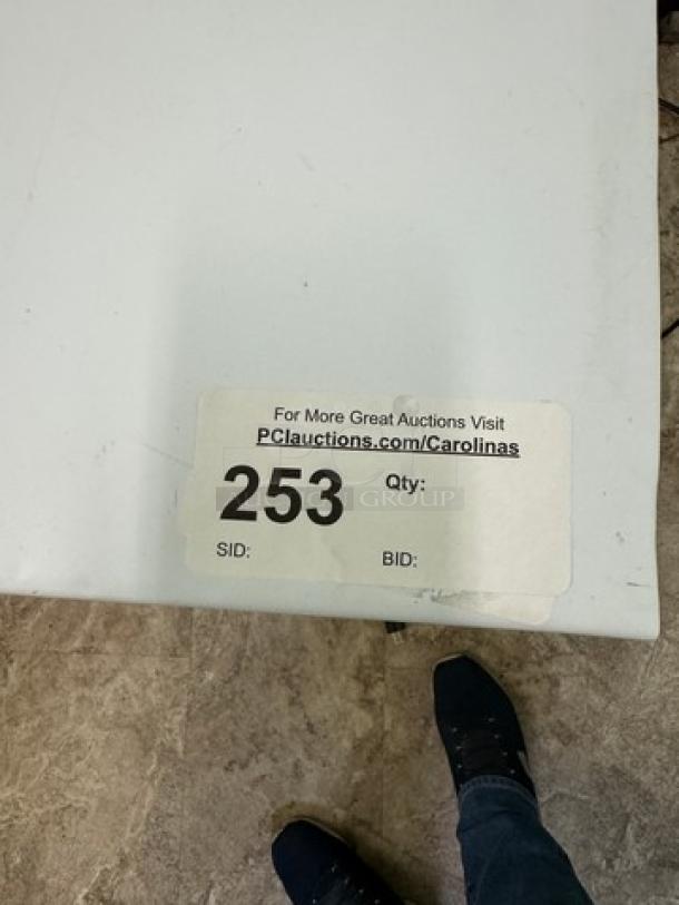 Atqsa chest freezer, white, in working condition. Auction label with ID "253" visible on the top surface.