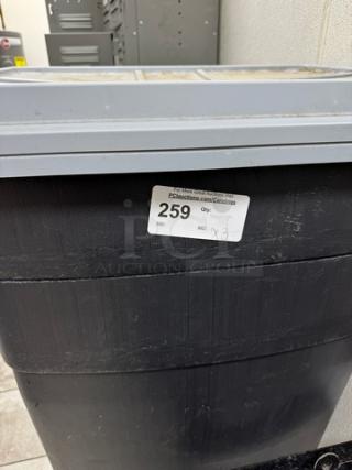 Large trash can, black plastic, grey lid, auction lot label "259". Signs of wear. 4 available for bid.
