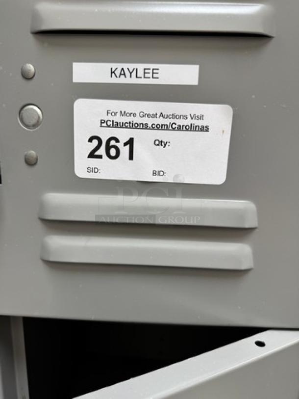 Gray metal 18-cubbie employee locker with visible labels. Good condition, ideal for organizing personal items.