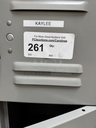 Gray metal 18-cubbie employee locker with visible labels. Good condition, ideal for organizing personal items.