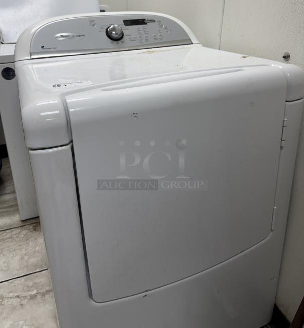 Whirlpool Cabrio washer dryer, white, with a top control panel, showing signs of wear. Energy Efficient model.