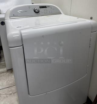 Whirlpool Cabrio washer dryer, white, with a top control panel, showing signs of wear. Energy Efficient model.