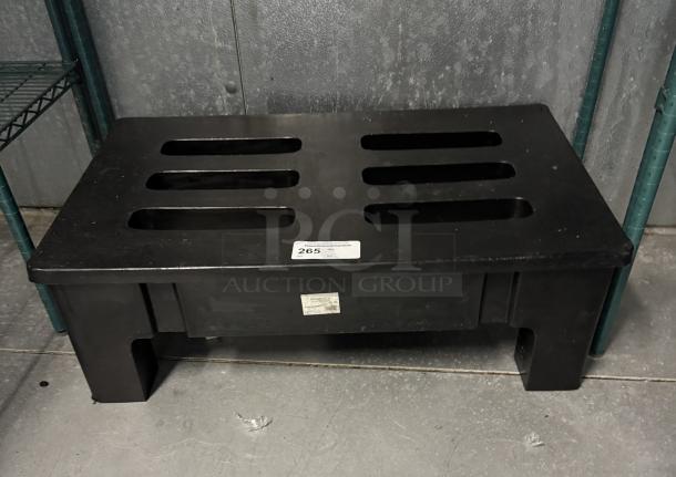 Black plastic dunnage rack with slotted top, in good condition. Labels indicating item number 265 affixed.