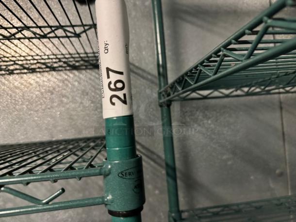 Green wire rack with 4 shelves, features a label marked "267" and NSF certification. Suitable for storage and organization.
