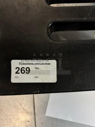 Black dunnage rack with a visible auction label "269" and website link. Sturdy, ideal for storage organization.