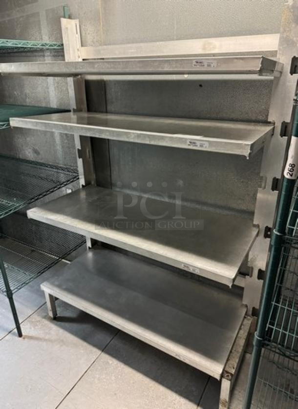Winholt metal rack with 4 shelves, model SCASS-2148. Sturdy steel construction, used condition, ideal for kitchen storage.