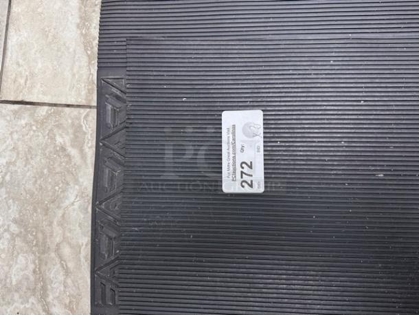 Black floor mats with ribbed texture, set of four. Tag indicates quantity as 4 and a lot number 272. Mats are in good condition.