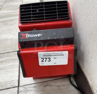 Lasko XBlower floor fan, red, model label intact; auction tag number 273; some visible dirt, used condition.
