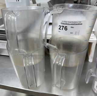 Four clear plastic 1-gallon pitchers with handles, each labeled with auction lot number 276.
