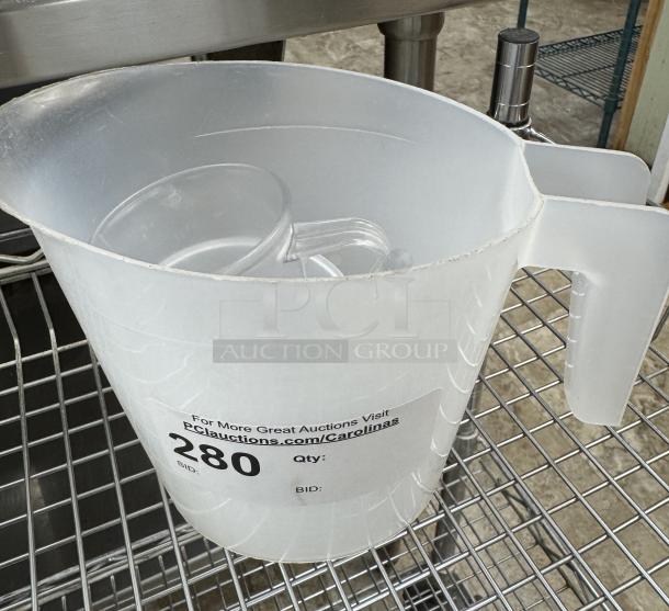 Three assorted measuring cups, large translucent plastic with handle, visible auction label bearing "280" in black text.