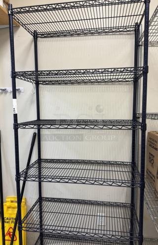 Wire rack with 6 black metal shelves, sturdy construction, good condition, visible label indicating storage capacity.