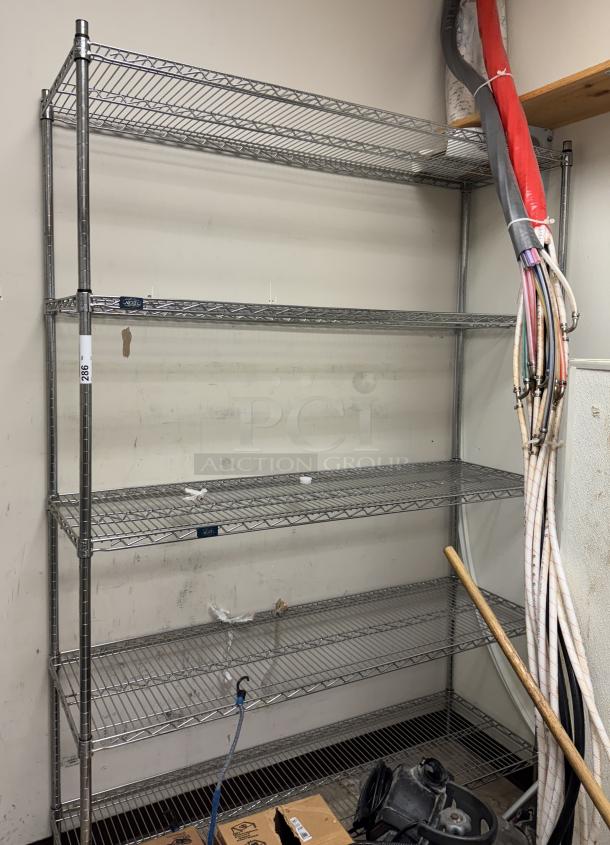 Knexel wire rack with 5 shelves, sturdy metal construction, used condition, suitable for storage or organization.