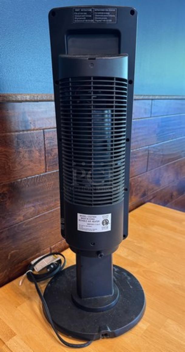 Lasko portable heater on a table, black finish, tested and working. Features power cord, rear ventilation grill, and model label.