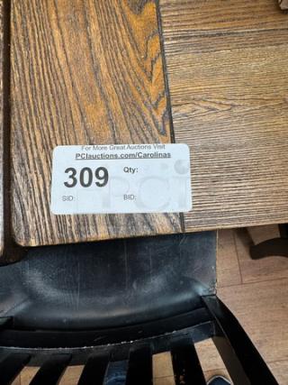 Wooden dining table with a rustic finish, visible wood grain. Auction tag reads "309." Appears in good condition.