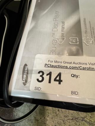 Samsung Blu-Ray Disc Player with remote, tested and working, includes user manual, auction tag number 314 visible.