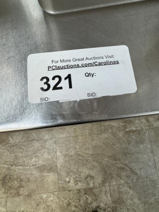 Stainless table with galvanized undershelf, visible auction label "321." Suitable for commercial use, durable condition.