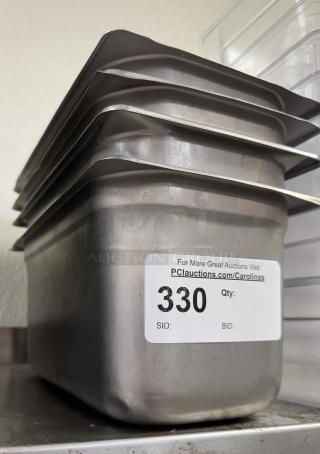 Stack of four Update stainless steel 1/3 x 6 pans showing lid, slight wear. Auction label indicates lot number 330.
