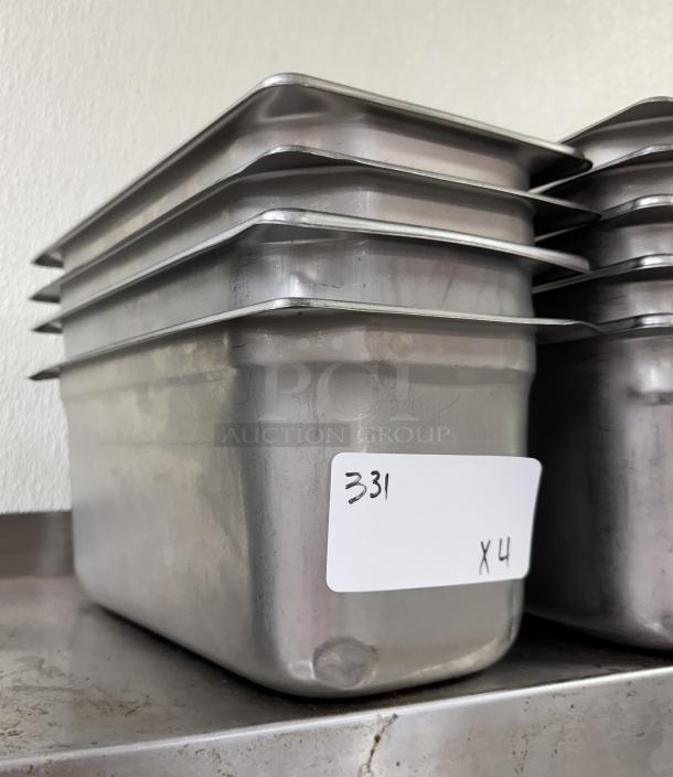 Stainless steel 1/3 size pans, stack of six, lightly used condition. Label reads "331 x4." Ideal for catering or restaurants.