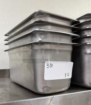 Stainless steel 1/3 size pans, stack of six, lightly used condition. Label reads "331 x4." Ideal for catering or restaurants.