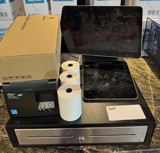 POS system with cash drawer, two tablets, Star TSP100 printer, extra ribbon box, and paper rolls. Appears in good condition.