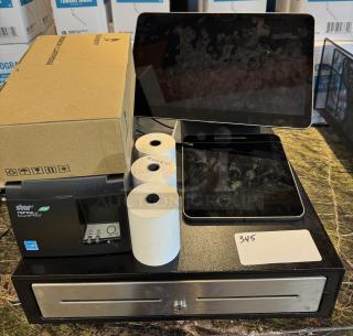 POS system with cash drawer, two tablets, Star TSP100 printer, extra ribbon box, and paper rolls. Appears in good condition.
