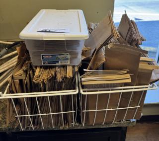 New lot of sealable paper bags in bins, includes Sterilite container. Ideal for packaging needs.