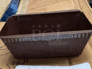 Disposable mini loaf pan with ribbed texture, brown paper material, clean condition. Ideal for baking small breads.