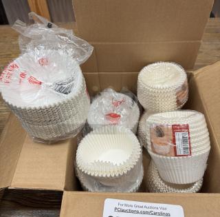 Jumbo cupcake liners in open box, multiple packs, labeled "Capri 130 pcs". New condition, white color.