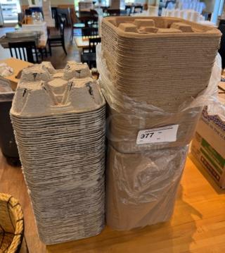 Stack of take out cup holder trays, new condition, made from recycled material, labeled with item number 377.