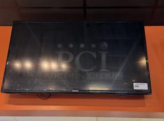 Samsung 52" TV with wall mount and remote. Tested, working, excellent condition. Model label visible on bottom.