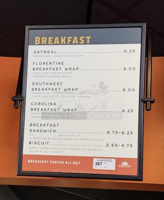 Framed hanging menu board displaying breakfast items with prices, labeled "Breakfast Served All Day," by Bake My Day.
