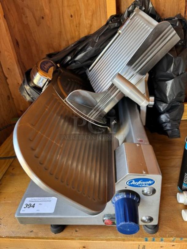 Chefmate Globe Slicer in working condition, features stainless steel body, adjustable blade, and control knobs. Tag shows item number 394.