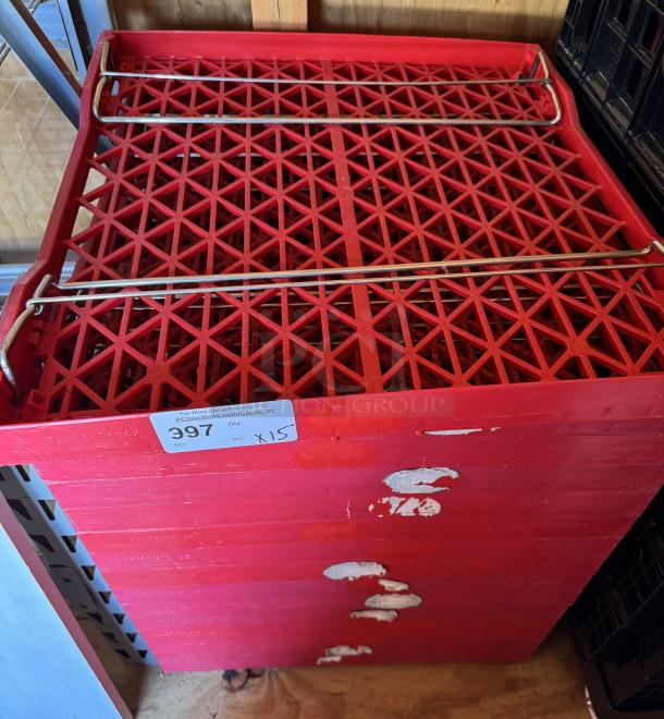 Red collapsible trays, stack of 15, visible label reads "Qty: X15 Bid: 397." Slight wear visible on surface.