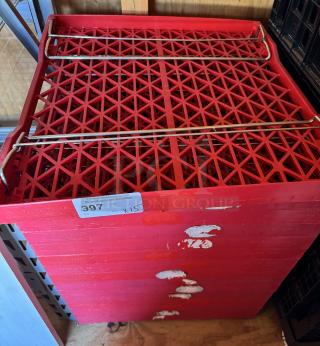 Red collapsible trays, stack of 15, visible label reads "Qty: X15 Bid: 397." Slight wear visible on surface.
