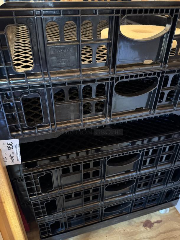 Stacked bakery bread racks with dollie, black plastic, lattice design, label reads "ORBIS Made in USA," set of 10 for auction.