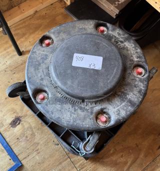 Trash can dolly in used condition, visible dust and wear, with four red caster attachments. Label reads "408 x3."