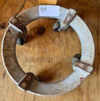 Cast iron mixing bowl dollie with four swivel casters, holding a 140 qt. mixing bowl. Slight rust visible, tag marked "409."