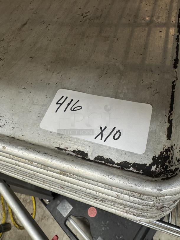 Set of full-size sheet pans, quantity 10. Visible wear and scratches, label "416 x10" indicates set size.